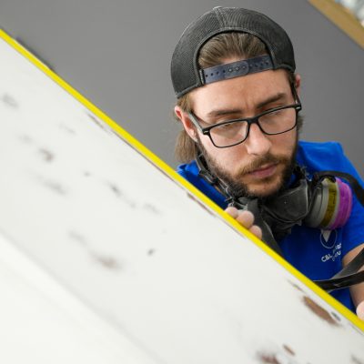 Paint technician prepping an interior piece for painting