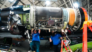 Two Aircraft Mechanics Working on an ERJ Engine